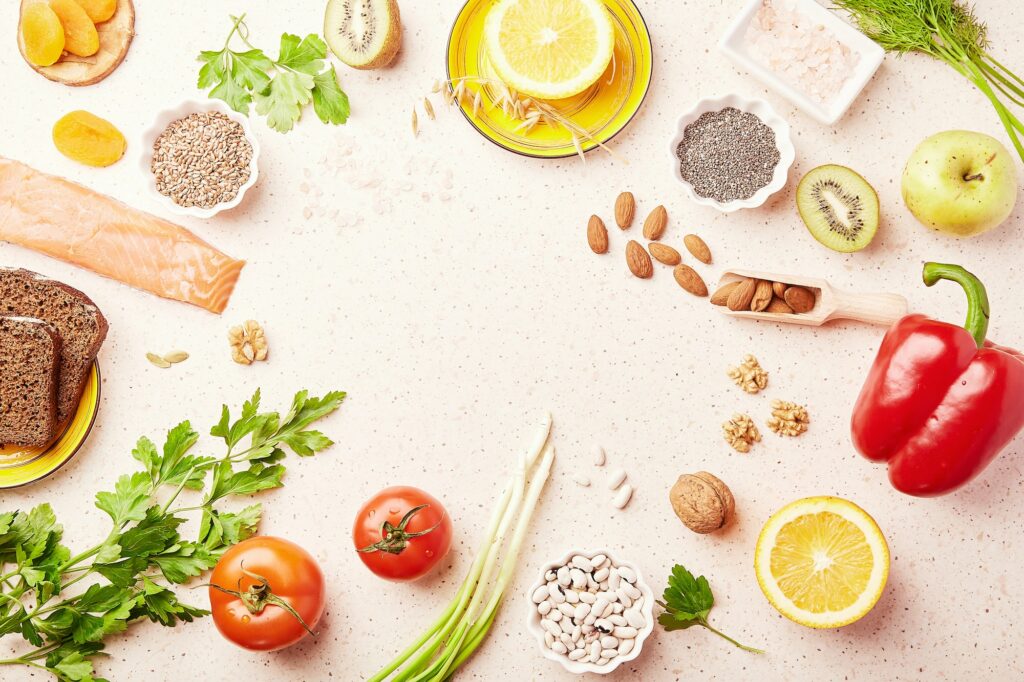 Healthy FODMAP diet food with copy space. Organic fruits, vegetables, greenery, nuts, beans