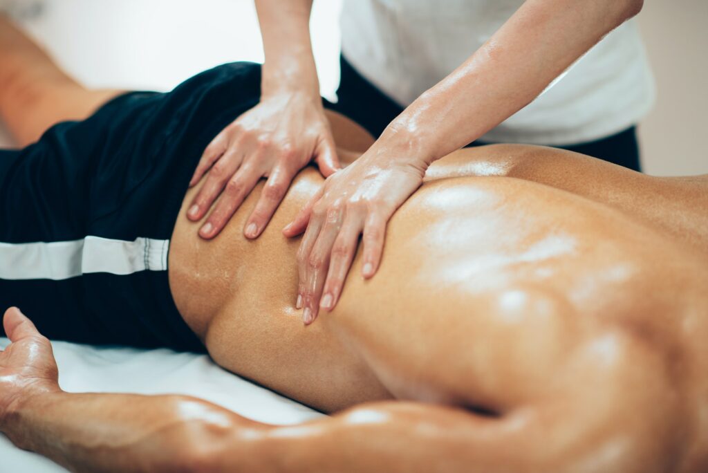 Sports massage. Therapist massaging lower back